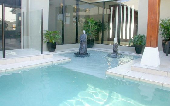 Pool with Sculpture Fountain — Pool Builders in Warana, QLD